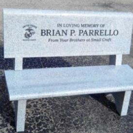 Gray park bench with In Loving Memory of Brian P. Parrello