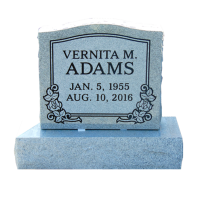 Gray headstone with flower engravings and name Vernita M. Adams